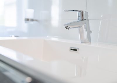 Close-up of a modern white sink and faucet.